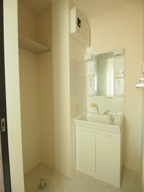 Washroom. Wash basin next to the space to put the shelf.