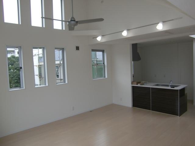 Living. From the east side of the living room. Sense of openness for the open kitchen is different. There is a hut back housed in the front. 