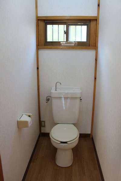 Toilet. It is a toilet with a small window.