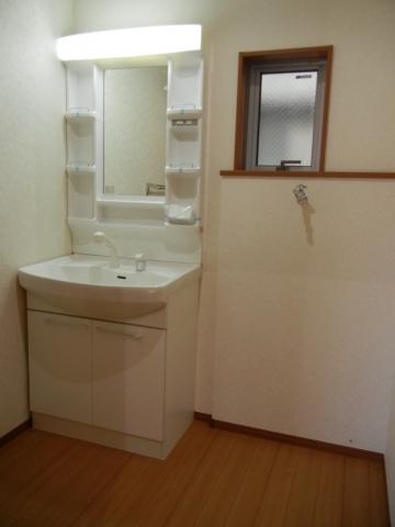 Wash basin, toilet. Ahead is a washroom image of the finished building.