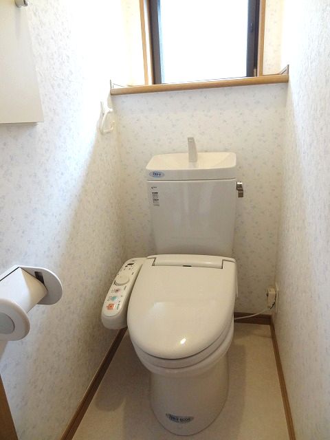 Toilet. Bidet and a small window with! 