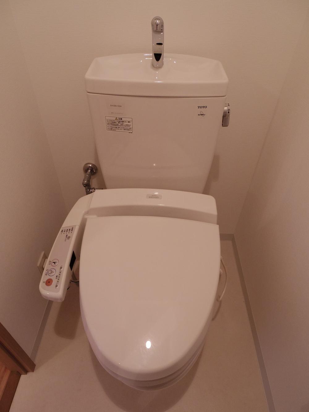 Toilet. Toilet is equipped with washing machine.