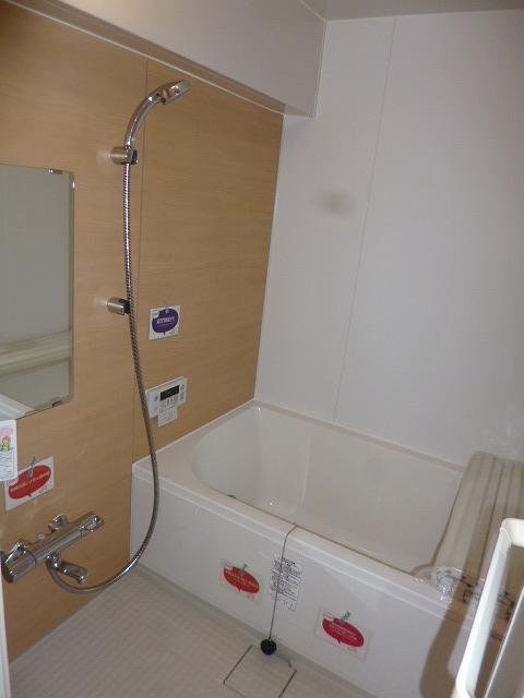 Bathroom. Panel of wood is accented. Flooring is also easy to dry the material is being used.