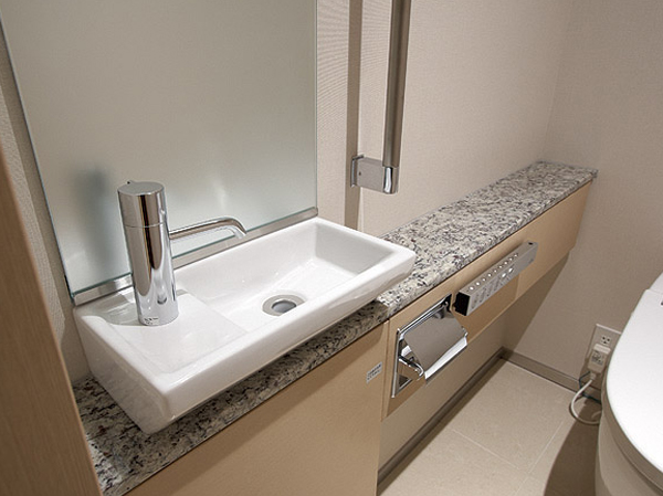 Toilet.  [Hand wash counter] Simple design employs an impressive natural stone of hand washing counter full of cleanliness. It will produce the space of the room to the toilet.
