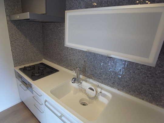 Kitchen. Mosaic tiles in the kitchen is decorated on the wall, Many storage, It becomes selfish nice space.