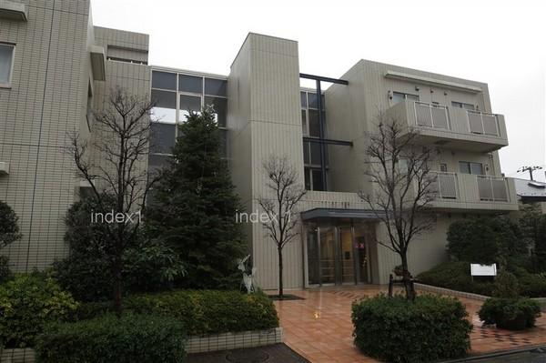 Local appearance photo. Green full of low-rise apartment