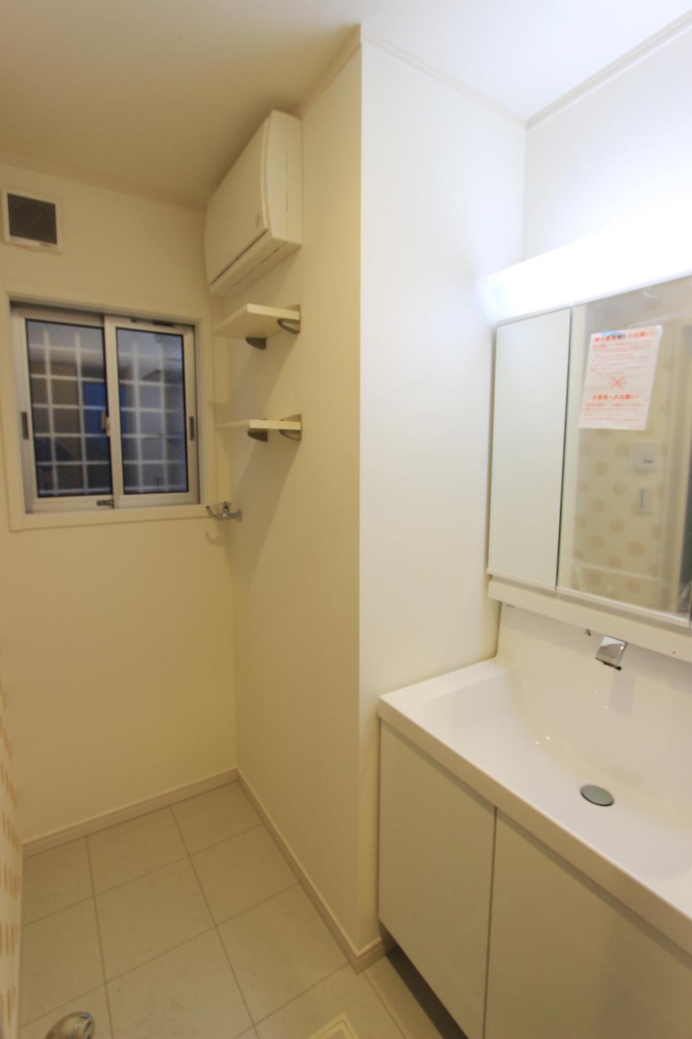 Wash basin, toilet. It has also been installed a small shelf in the washroom.