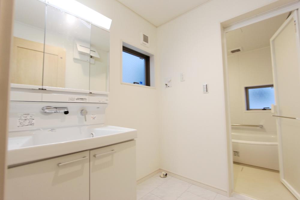 Wash basin, toilet. It is has been cleanliness some space unified with white.