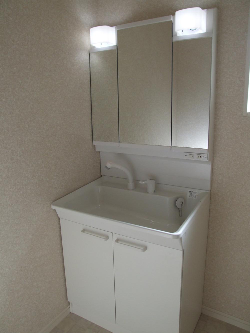 Wash basin, toilet. Washbasin housed a lot of! 