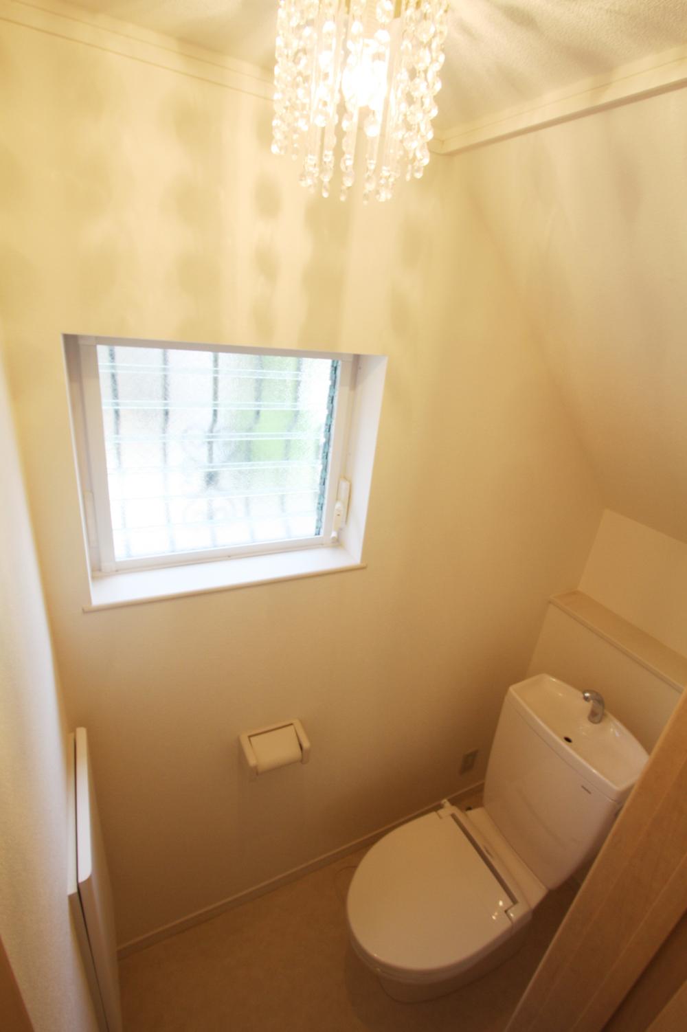 Toilet. 1F toilet that take advantage of the under stairs