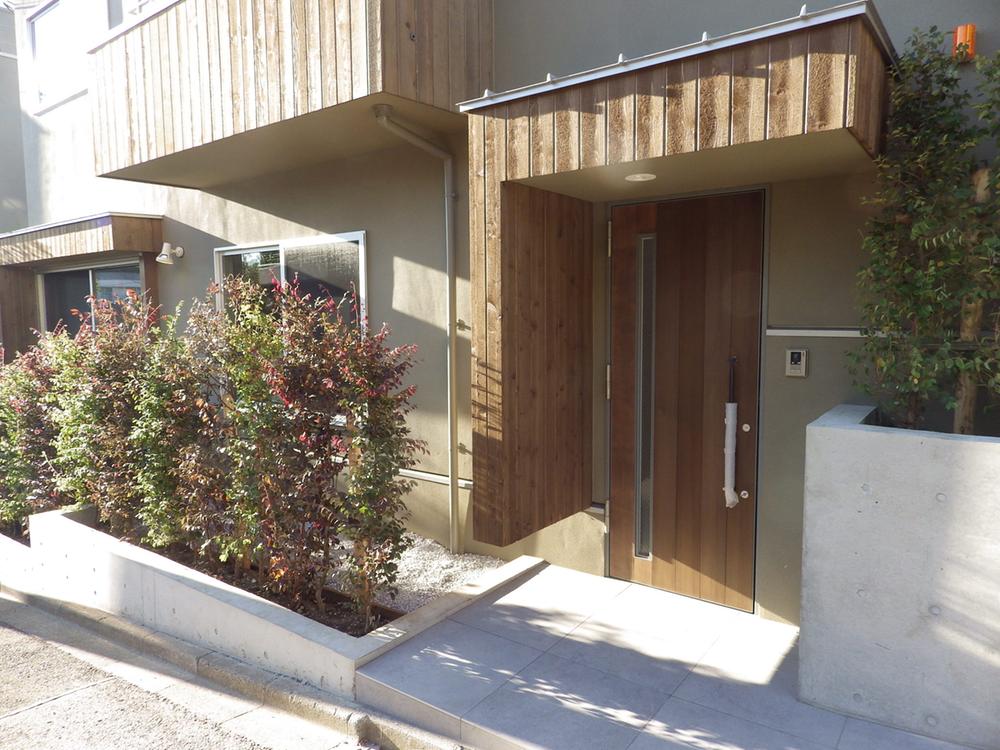 Entrance. There is also parked space and planting in the entrance space next to that is designed in the center of the housing