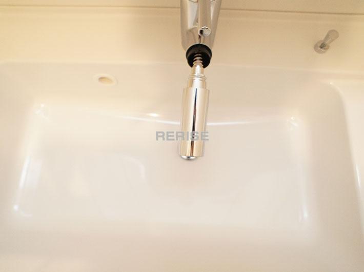 Wash basin, toilet. Vanity with a shower head