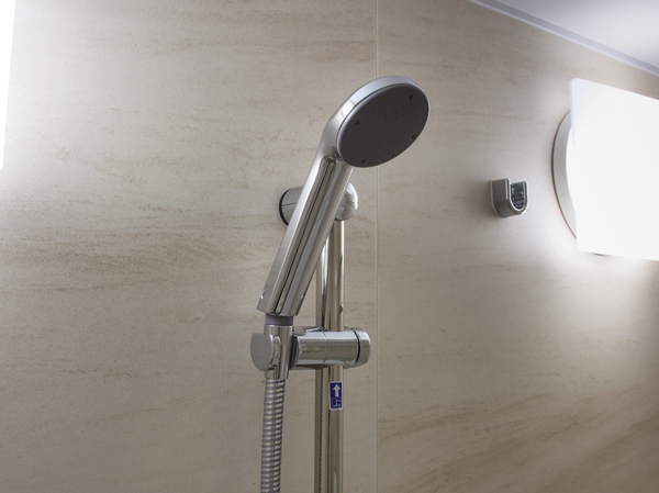 Bathing-wash room.  [Slide bar shower head] A slide bar that can be adjusted to the height of your choice has been set the shower head with.