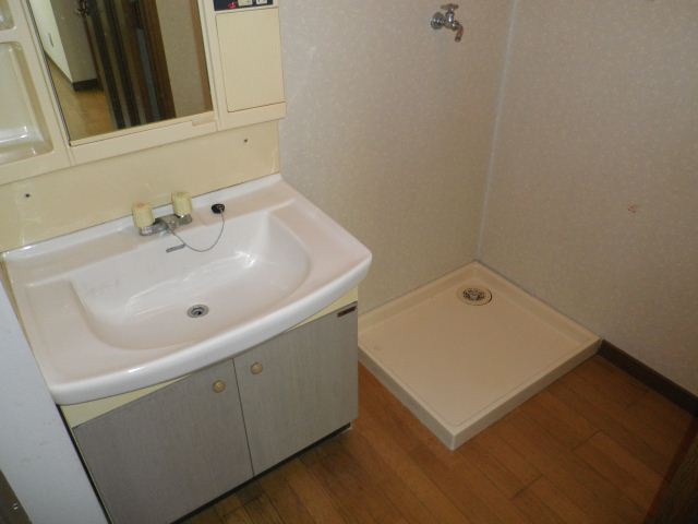 Washroom. Wash basin and washing machine inside the room