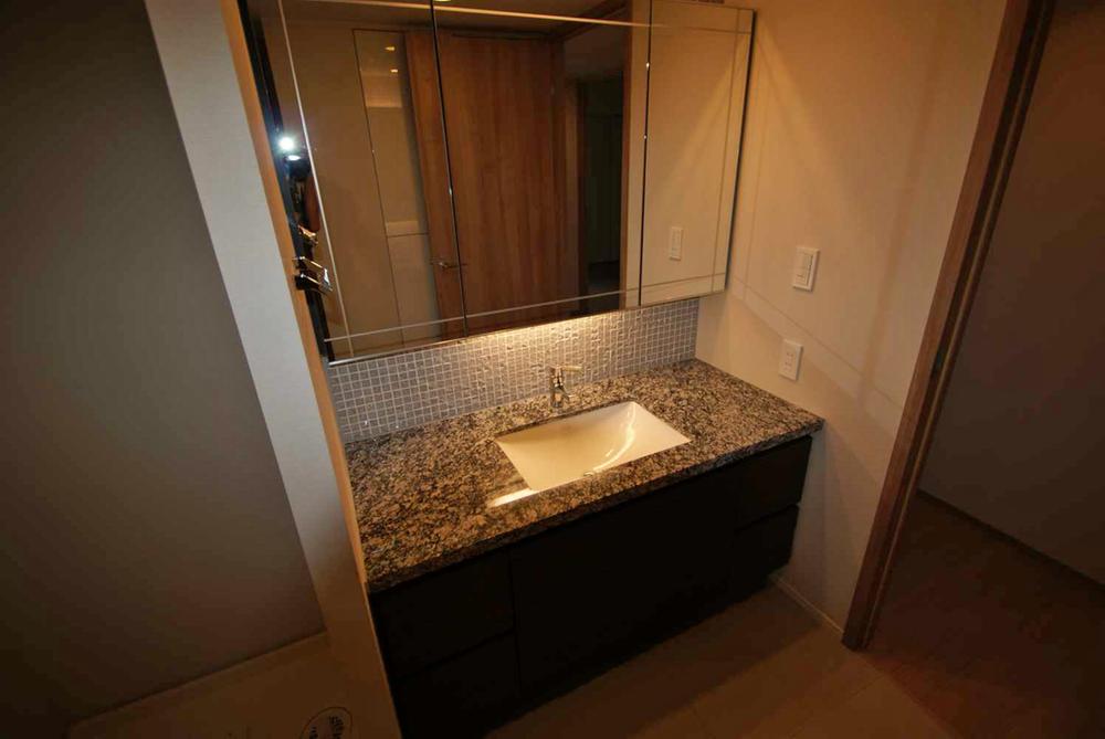 Wash basin, toilet. Widely when compared to the House for washroom, It comes with a storage on the back.
