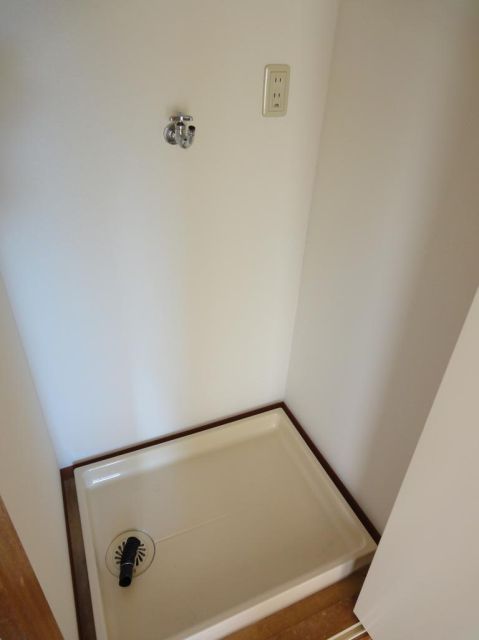 Other room space. Washing machine in the room.