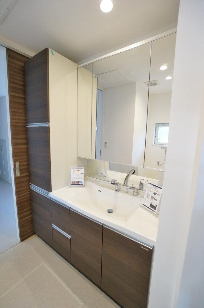 Wash basin, toilet. Washroom that storage has been enhanced.