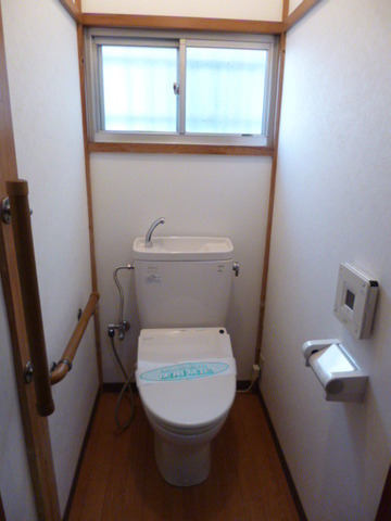 Toilet. It is with cleaning warm toilet seat. It is a sliding door.