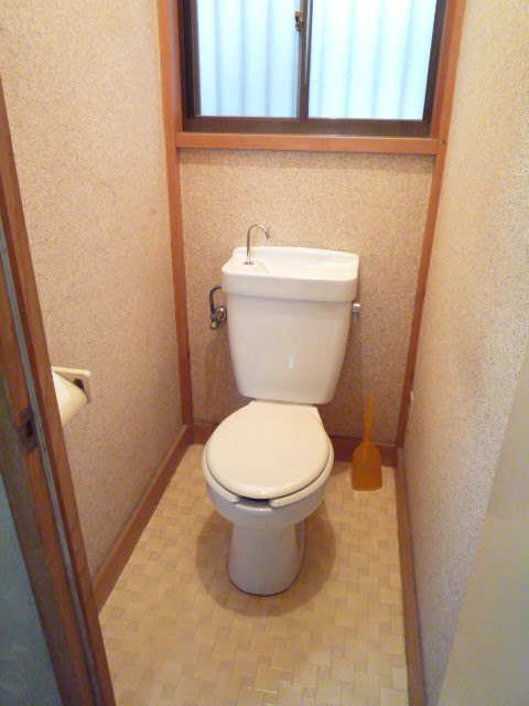 Toilet. There is a window in the toilet.