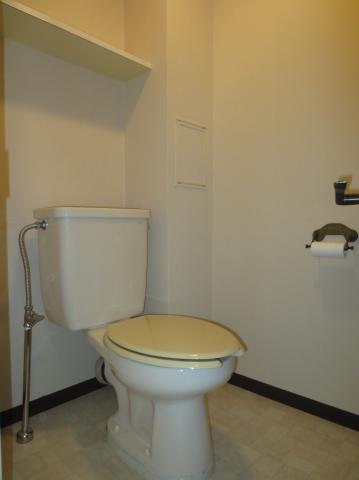 Toilet. Hand wash bowl is attached to the toilet.