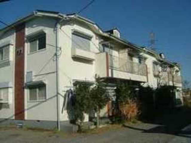 Building appearance. Sunny parking lot right in front of