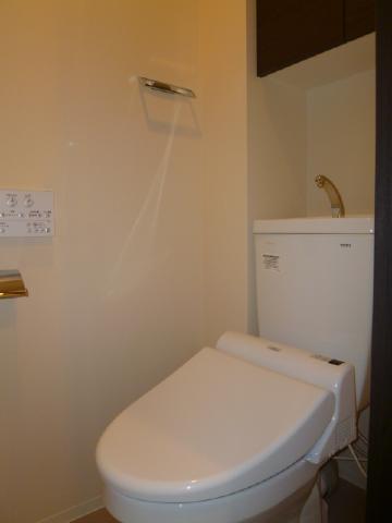 Toilet. Toilet, It is with a cleaning function. Also it comes with a storage rack.