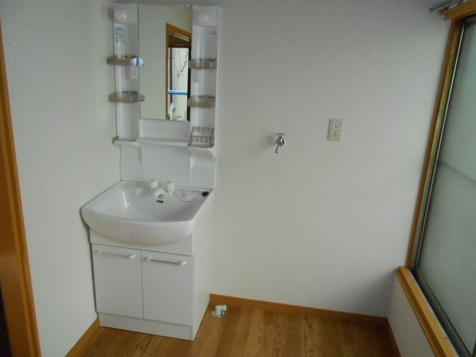 Washroom. There is a washing machine place to wash basin next to