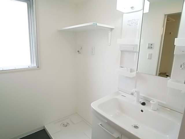 Washroom. Washing machine in the room is located in the basin undressing room. Bright impression with window.