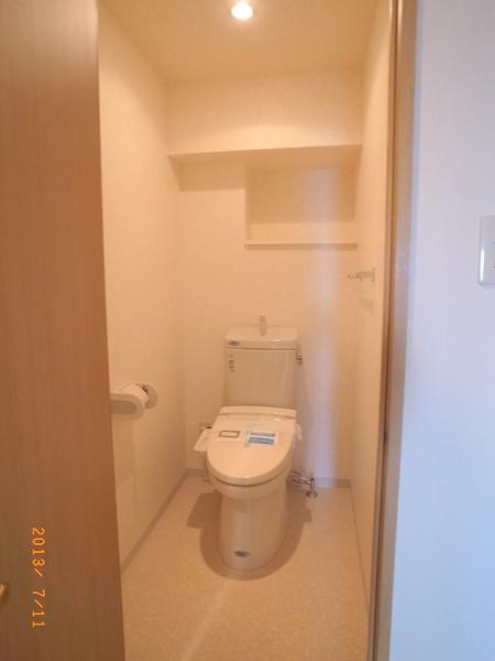 Toilet. The apartment is a reference photograph.