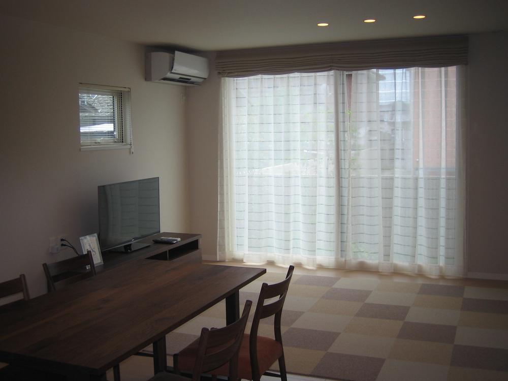 Living. It is a bright living room with large opening